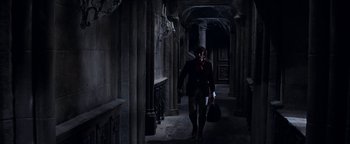 Movie still from “The Fearless Vampire Killers” (1967), directed by Roman Polanski – A man walking down a hallway in a dark place; Wide shot, High angle