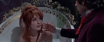 Movie still from “The Fearless Vampire Killers” (1967), directed by Roman Polanski – A woman with long red hair is being held up by a man; Close Up shot, Over the shoulder angle