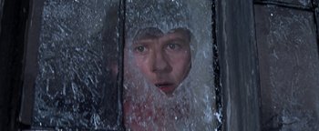 Movie still from “The Fearless Vampire Killers” (1967), directed by Roman Polanski – A man looking out of a window through a glass door; Close Up shot, High angle