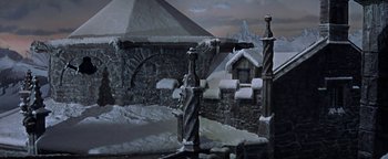 Movie still from “The Fearless Vampire Killers” (1967), directed by Roman Polanski – A painting of a castle with snow on the ground; Extreme Wide shot, High angle