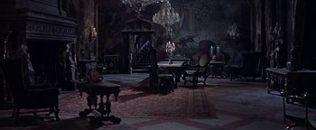 Movie still from “The Fearless Vampire Killers” (1967), directed by Roman Polanski – A room filled with lots of furniture and a chandelier; Wide shot, High angle