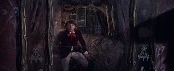 Movie still from “The Fearless Vampire Killers” (1967), directed by Roman Polanski – A man wearing a red bow tie and a red jacket; Medium shot, Low angle