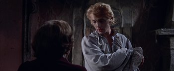 Movie still from “The Fearless Vampire Killers” (1967), directed by Roman Polanski – A man in a white shirt is talking to another man in a red shirt; Medium shot, Over the shoulder angle