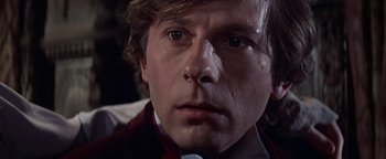 Movie still from “The Fearless Vampire Killers” (1967), directed by Roman Polanski – A person wearing a suit and tie; Close Up shot, Low angle