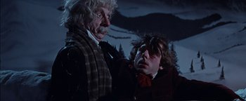 Movie still from “The Fearless Vampire Killers” (1967), directed by Roman Polanski – A man and a woman standing next to each other in front of a forest; Medium shot, Low angle