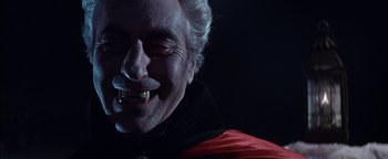 Movie still from “The Fearless Vampire Killers” (1967), directed by Roman Polanski – An older man with a vampire fangs smiling for the camera; Close Up shot, Low angle