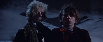 Movie still from “The Fearless Vampire Killers” (1967), directed by Roman Polanski – Two men standing next to each other in front of a dark background; Close Up shot, Low angle