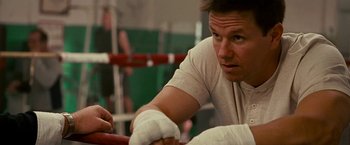 Movie still from “The Fighter” (2010), directed by David O. Russell – A man in white shirt and white bandages on his hands; Close Up shot, Over the shoulder angle
