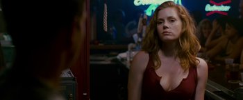 Movie still from “The Fighter” (2010), directed by David O. Russell – A woman in a red dress standing in front of a mirror; Close Up shot, Over the shoulder angle