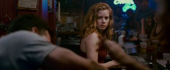 Movie still from “The Fighter” (2010), directed by David O. Russell – A woman sitting at a table in front of a mirror; Medium shot, Over the shoulder angle