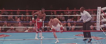 Movie still from “The Fighter” (2010), directed by David O. Russell – Two boxers in a boxing ring in front of a crowd of people; Medium shot, High angle