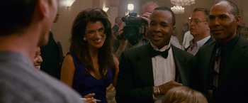Movie still from “The Fighter” (2010), directed by David O. Russell – A man and a woman are smiling for the camera; Medium shot, Over the shoulder angle