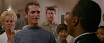 Movie still from “The Fighter” (2010), directed by David O. Russell – A group of men standing next to each other in a room; Close Up shot, Over the shoulder angle