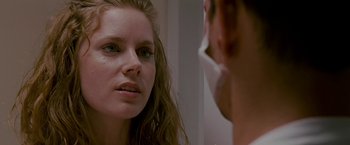 Movie still from “The Fighter” (2010), directed by David O. Russell – A woman looking into a mirror while holding a cell phone; Close Up shot, Over the shoulder angle