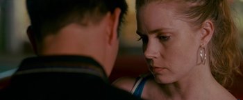 Movie still from “The Fighter” (2010), directed by David O. Russell – A man and a woman looking at one another; Close Up shot, Over the shoulder angle