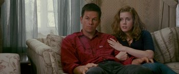 Movie still from “The Fighter” (2010), directed by David O. Russell – A man and a woman sitting on a couch together; Medium shot, High angle