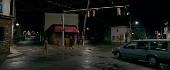 Movie still from “The Fighter” (2010), directed by David O. Russell – A car parked in the middle of the street at night; Extreme Wide shot, High angle