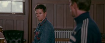 Movie still from “The Fighter” (2010), directed by David O. Russell – A man standing in front of another man in front of a wall; Close Up shot, Over the shoulder angle