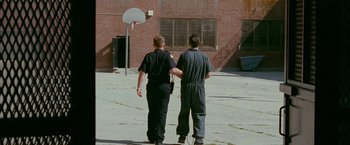 Movie still from “The Fighter” (2010), directed by David O. Russell – A couple of people that are walking in the street; Wide shot, High angle