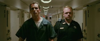 Movie still from “The Fighter” (2010), directed by David O. Russell – Two police officers are standing in a hallway; Medium shot, Low angle