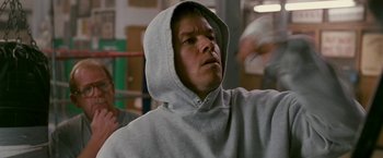Movie still from “The Fighter” (2010), directed by David O. Russell – A man wearing a hooded sweatshirt in a boxing ring; Close Up shot, Low angle