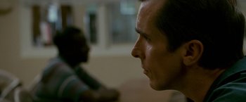 Movie still from “The Fighter” (2010), directed by David O. Russell – A person's face with a blurry background; Close Up shot, Over the shoulder angle