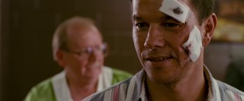 Movie still from “The Fighter” (2010), directed by David O. Russell – A person with a bandage on his head; Close Up shot, Over the shoulder angle