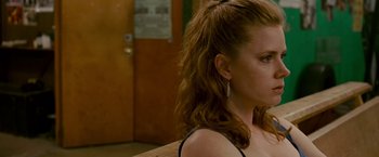 Movie still from “The Fighter” (2010), directed by David O. Russell – A person with long red hair; Close Up shot, Over the shoulder angle