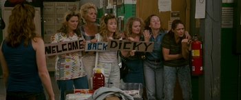 Movie still from “The Fighter” (2010), directed by David O. Russell – A group of women standing next to each other holding signs; Wide shot, High angle