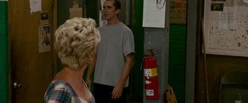Movie still from “The Fighter” (2010), directed by David O. Russell – A man and a woman standing next to a fire hydrant; Medium shot, Over the shoulder angle