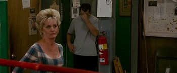 Movie still from “The Fighter” (2010), directed by David O. Russell – A man standing next to a woman in front of a fire hydrant; Medium shot, Over the shoulder angle