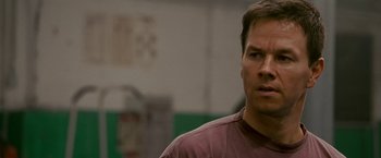 Movie still from “The Fighter” (2010), directed by David O. Russell – A person wearing a maroon shirt; Close Up shot, Over the shoulder angle