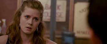 Movie still from “The Fighter” (2010), directed by David O. Russell – A person with long brown hair; Close Up shot, Over the shoulder angle