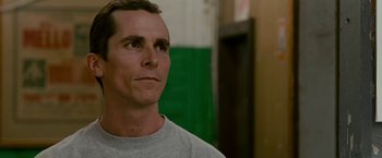 Movie still from “The Fighter” (2010), directed by David O. Russell – A person wearing a gray t - shirt; Close Up shot, Low angle