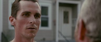 Movie still from “The Fighter” (2010), directed by David O. Russell – A man's face in front of a house; Close Up shot, Over the shoulder angle