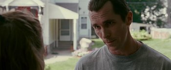 Movie still from “The Fighter” (2010), directed by David O. Russell – A person wearing a gray t - shirt; Close Up shot, Over the shoulder angle
