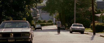 Movie still from “The Fighter” (2010), directed by David O. Russell – A man walking down the street on a skateboard; Extreme Wide shot, Low angle