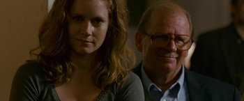 Movie still from “The Fighter” (2010), directed by David O. Russell – A man and a woman sitting next to each other; Close Up shot, Over the shoulder angle
