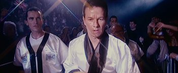 Movie still from “The Fighter” (2010), directed by David O. Russell – A person wearing a white shirt and a black tie; Close Up shot, Over the shoulder angle