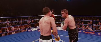 Movie still from “The Fighter” (2010), directed by David O. Russell – Two men in a boxing ring during a match; Medium shot, High angle