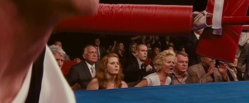 Movie still from “The Fighter” (2010), directed by David O. Russell – A group of people sitting in a boxing ring; Medium shot, High angle