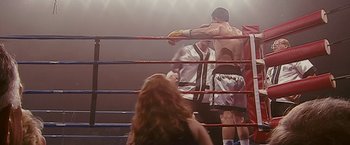 Movie still from “The Fighter” (2010), directed by David O. Russell – A man and a woman in a boxing ring; Medium shot, Over the shoulder angle