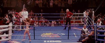 Movie still from “The Fighter” (2010), directed by David O. Russell – An old man in a boxing ring in front of a crowd of people; Wide shot, High angle