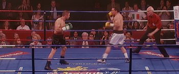 Movie still from “The Fighter” (2010), directed by David O. Russell – Two boxers in a boxing ring facing each other in front of a crowd; Medium shot, High angle