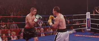 Movie still from “The Fighter” (2010), directed by David O. Russell – Two boxers in a boxing ring during a match; Medium shot, High angle