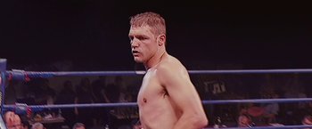 Movie still from “The Fighter” (2010), directed by David O. Russell – A man standing in the middle of a boxing ring; Close Up shot, Low angle
