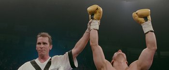 Movie still from “The Fighter” (2010), directed by David O. Russell – Two boxers are fighting in a boxing ring; Medium shot, Low angle