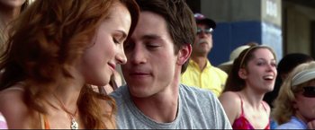 Movie still from “The Final Destination” (2009), directed by David R. Ellis – A man and a woman face to face in front of a group of people; Close Up shot, Over the shoulder angle