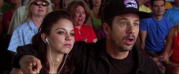 Movie still from “The Final Destination” (2009), directed by David R. Ellis – A man and a woman sitting next to each other in front of an audience; Close Up shot, Over the shoulder angle