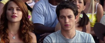 Movie still from “The Final Destination” (2009), directed by David R. Ellis – A man sitting in front of a group of other people; Close Up shot, Over the shoulder angle